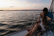 © Westend61 - Couple kissing on yacht during summer vacation at sea at sunset