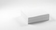 © The 2R Artificiality - A thick stack of blank white paper displayed on a flat white surface with diffused light