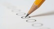 © AkuAku - Close-up photo of sharpened yellow pencil filling in answer on white assessment paper showing black bubbles in educational context