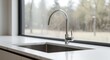 © AkuAku - kitchen sink layout with wide glass window and contemporary streamlined faucet