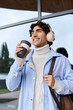 © LIGHTFIELD STUDIOS - Handsome young man enjoys coffee outdoors in urban area with stylish outfit