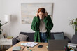 © LIGHTFIELD STUDIOS - Young woman with red hair enjoying music in her cozy modern apartment