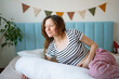 © wifesun - Pregnant woman experiencing ultimate comfort and support in bed, resting with her maternity pillow, relaxing at home during pregnancy, enjoying a moment of personal wellness
