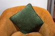 © Nattawit - Green pillow on brown sofa seat in luxury living room. Interior decoration furniture object. Close-up and selective focus.