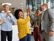 © Lumos sp - Portrait of a businesswoman celebrating during a meeting in office, group of businesspeople celebrating success, applauding and smiling, teamwork concept