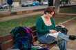© Cristian Blázquez - Woman embroidering outdoors on park bench