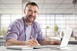 © BillionPhotos.com - Confident young male professional working in modern office.