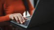 © Thawatchai Images - Close up of a woman's hands with orange nails typing on a laptop keyboard. Concept of remote work, professional freelancer, online business communication, and modern digital lifestyle.