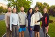 © Studio Romantic - Group of runners standing together after jogging in summer city park. Happy team of people training on path outdoors, portrait of athletes on route, workout with healthy fitness energy and teamwork