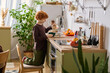 © Bliss - Little boy enjoying a cozy breakfast moment in a bright kitchen filled with plants