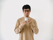 © Sevendeman - Man in a tan shirt is holding a white coffee cup