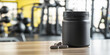 © plysuikvv - Black container with fitness supplement on gym table Generative AI