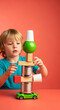 © Svetlana Kulakova - A young boy concentrating on stacking toys and objects against a vibrant background