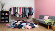 © Yasin - Messy room with clothes scattered on the floor and a clothing rack full of garments