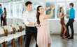 © JackF - Couple of young guy and young woman dancing waltz in studio