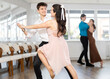© JackF - Young man and young woman dance pair tango dance in studio