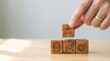 © Leocetke - Hand arranging wooden blocks with business strategy, teamwork, leadership, and growth icons.