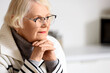 © Pixel-Shot - Thoughtful senior woman in kitchen, closeup