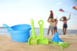 © New Africa - Beach toys on sand and family with children by sea, selective focus