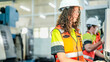 © ultramansk - Mechanical production operator executing industrial machinery maintenance protocols. Skilled female worker inspecting manufacturing quality standards.
