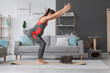 © Pixel-Shot - Sporty pregnant woman with cute cat doing yoga on mat at home