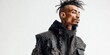 © NovaVision - Young man with dreadlocks and tattoos wearing a studded leather jacket and hoodie