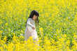 © mei - A girl in Hanfu in a spring rapeseed flower field