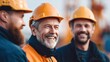 © NovaVision - Happy construction workers smiling while working together at a construction site.