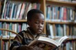 © Rawpixel.com - Black little boy Students reading library book.