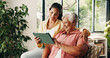 © OnPoint/peopleimages.com - Tablet, elderly mother or daughter on couch, digital photo album or view nostalgic image for bonding. Smile, social media memory or women with tech to watch family movie, browsing or support in home