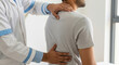 © PIX OF WORLD AI - Doctor Examining Patient's Back and Neck for Pain Assessment