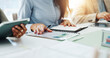 © DavidsPrime/peopleimages.com - Documents, hands and meeting with business person in office boardroom for collaboration or planning. Folder, notebook and workshop with employee at desk in workplace for agenda or project management