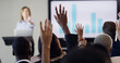 © Kobus Louw/peopleimages.com - Presentation, audience and woman with hands raised for conference, training and meeting. Business people, discussion and questions in workshop, convention or seminar for financial coach with graph
