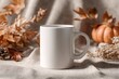 © Zee Production - White Coffee Mug Mockup with Autumn Fall Leaves and Pumpkin Decor