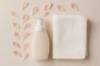 © Татьяна Евдокимова - Foaming soap bottle and folded white cotton towel with delicate pink flower petals on a light beige background