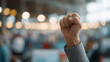 © pattozher - Empowered Hand Gesture: A close-up shot of a hand clenched into a fist, raised with conviction, symbolizing strength, resistance, and determination in a blurred backdrop.