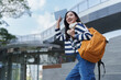 © crizzystudio - Asian student woman walking up stairs holding notebook