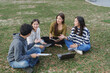 © crizzystudio - Young asian students collaborating outdoors on a group project