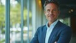 © COK House - A smiling man in a business suit standing by a window with a cityscape creates an atmospheric backdrop for presentations on leadership and corporate culture.