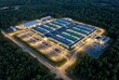 © Nadia - Hyperscale data center campus aerial view at dusk surrounded by forest