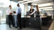 © ASDF - A group of people are standing in a room, some of them are holding laptops