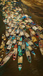 © AmazingAerialAgency - Aerial view of boats clustered densely on the river, a vibrant tapestry of colors against the muddy water and sandy banks, Sunamganj, Sylhet, Bangladesh.