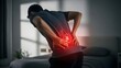 © IrmaPrastiwi - Man Experiencing Severe Kidney Stone Pain at Home with Red Highlight on Lower Back Area