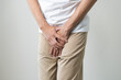 © KMPZZZ - Closeup annoying itch asian man with an itchy his jock and butt, male scratching crotch with his hand, itching groin, male suffering body problem. Health care, hygiene, skin disease, medicine concept.