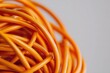 © ai_katrin - orange electrical cables tangled and intertwined in complex chaotic knot