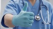 © Sophia - Medical Professional in Scrubs and Gloves Giving Thumbs-Up for Quality Care and Health Success