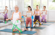 © JackF - Women are doing stretching exercise with resistance bands. Teamwork, good mood and healthy lifestyle concept