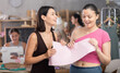 © JackF - Two young women discussing sewn pattern during sewing master class