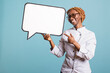 © DC Studio - African American female chef in uniform pointing at empty signboard against isolated background. Professional cook holds speech bubble, inviting creative messages for restaurant or culinary campaigns.