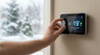 © krismicrostoker - A person is adjusting the thermostat to 22 degrees